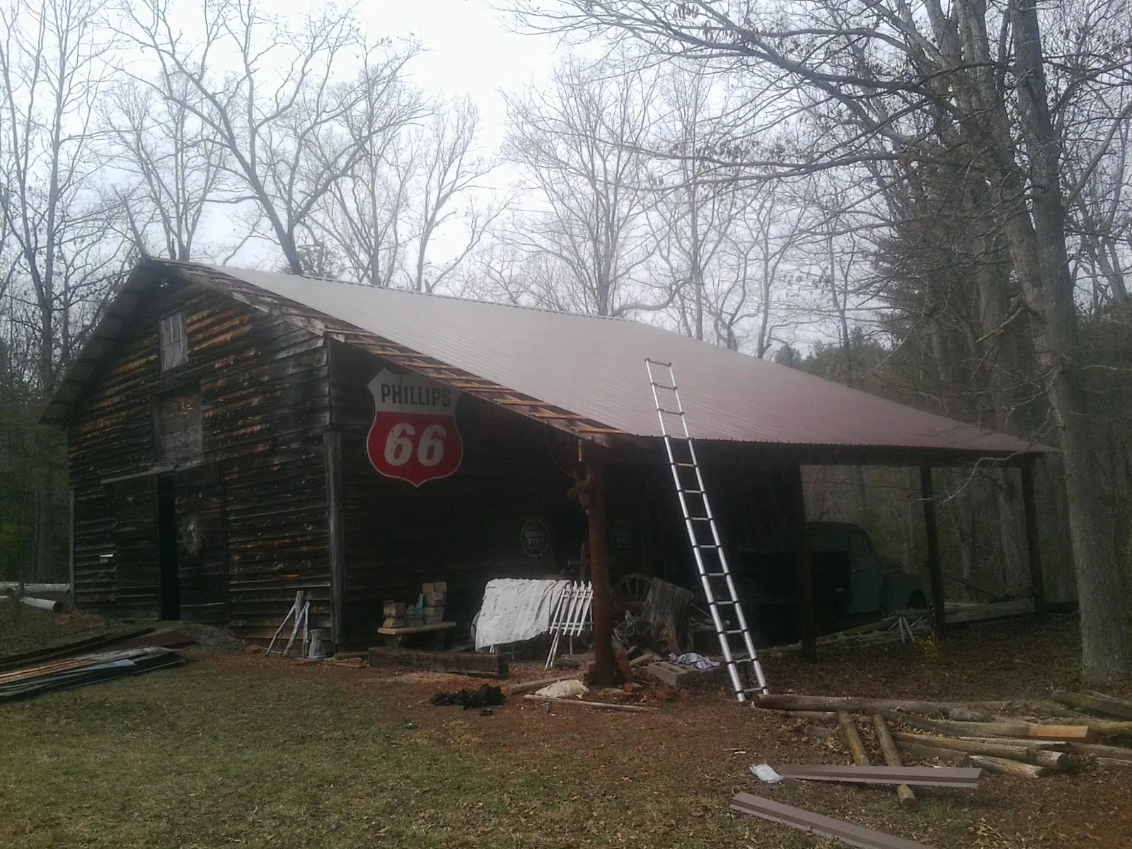 New metal roof on an open sided timber barn with a vintage sign in Declo