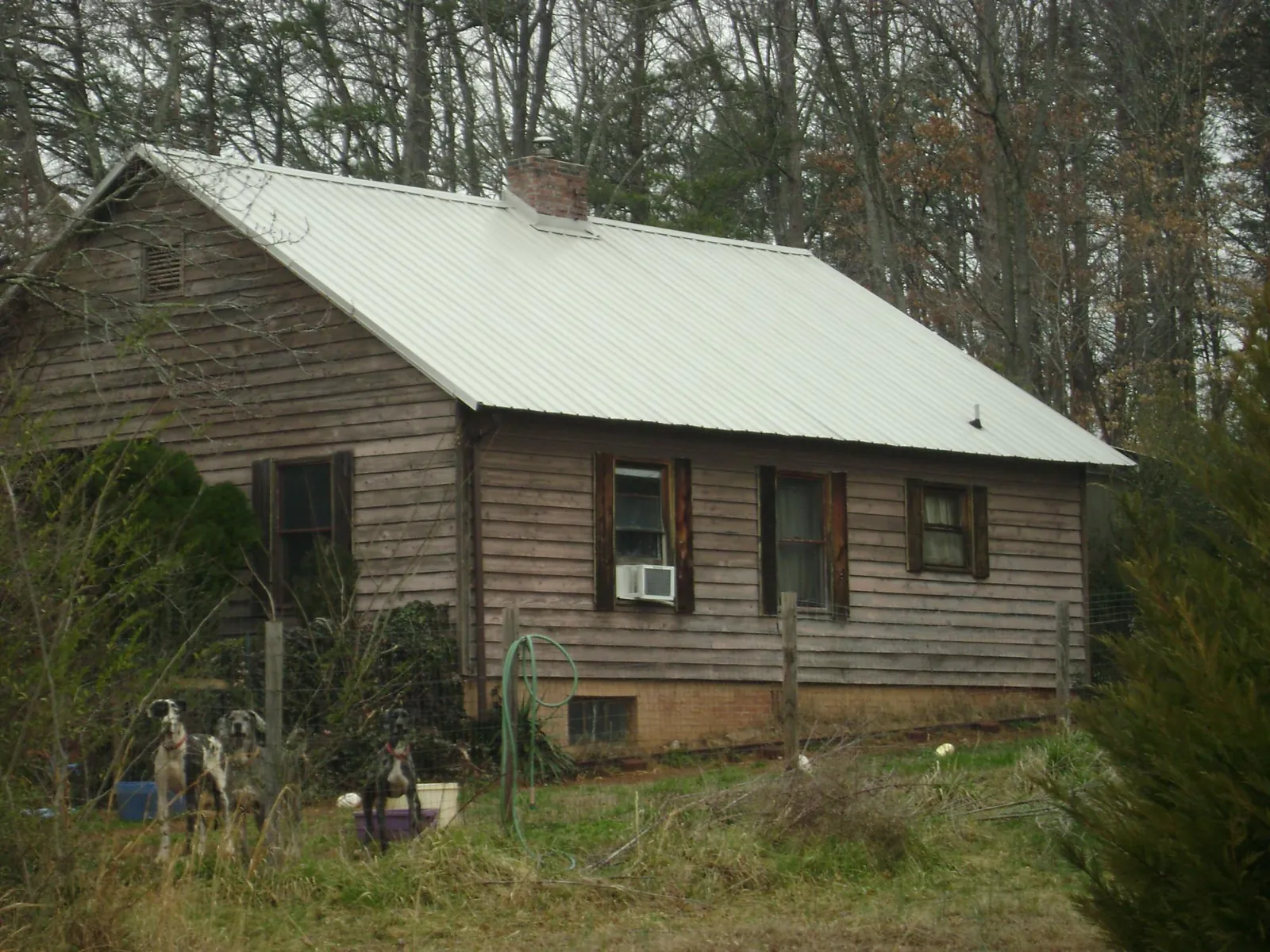 White metal roof on an old wood sided farmhouse, from a Metal Roof Installation job in Declo
